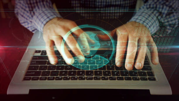 istock Man writing on laptop keyboard with head shape hologram 1141022945