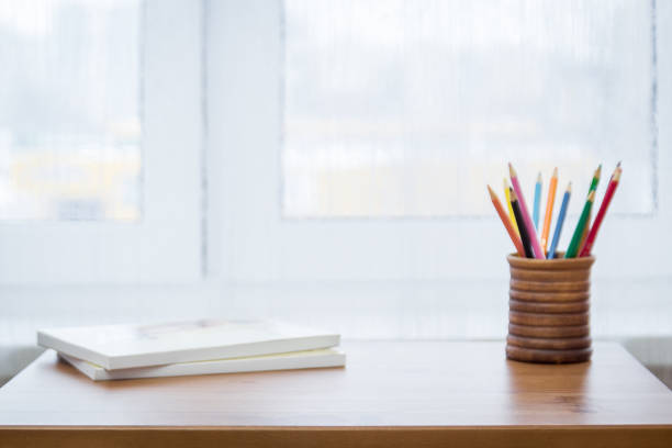 istock Background with pencils, notebooks and window 1141026074