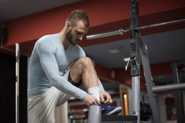 istock Man tying jogging shoes 1141026216