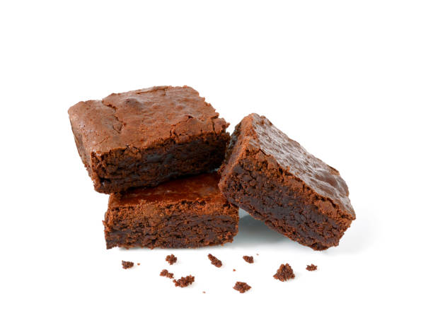 Pile of homemade brownies with crumbs Pile of homemade brownies with crumbs isolated on white background fudge stock pictures, royalty-free photos & images