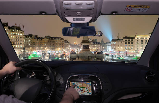 driving using gps towards  trafalgar square at night, london, uk - car dashboard night driving imagens e fotografias de stock