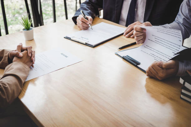 istock Two selection committee manager reading a resume during a job interview, Employer interviewing to ask young female job seeker for recruitment talking in office 1141029734