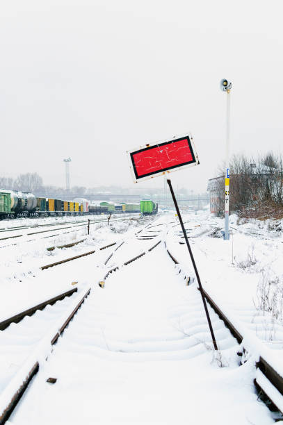 railroad tracks in the snow. commodity railway wagons, winter. vertical photography. - connection merger road togetherness imagens e fotografias de stock