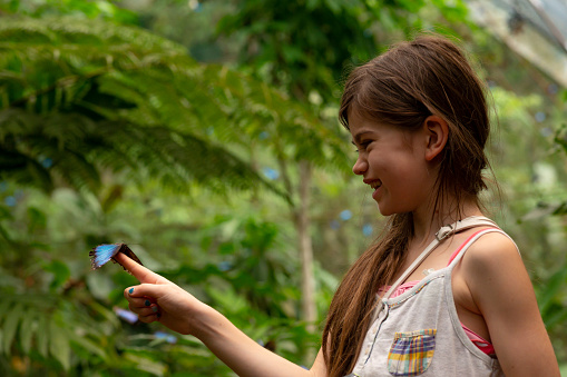 Girl holding a butterfly in Costa Rica