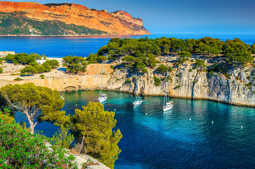 Fantastic vacation place, stunning viewpoint on the cliffs, Calanques de Port Pin bay with yachts and sailing boats, Calanques National Park near Cassis, Provence, South France, Europe