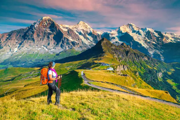 Photo of Mannlichen tourist station with backpacker hiker woman, Grindelwald, Switzerland, Europe