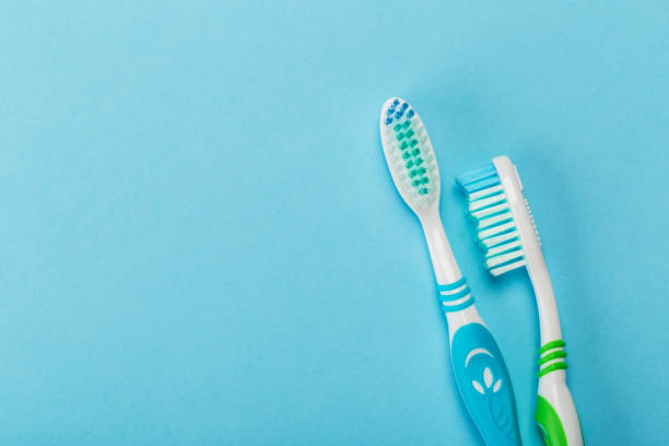 istock Two new toothbrush on a blue background. Dental concept 1141034880