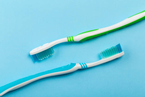 istock Two new toothbrush on a blue background. Dental concept 1141034984
