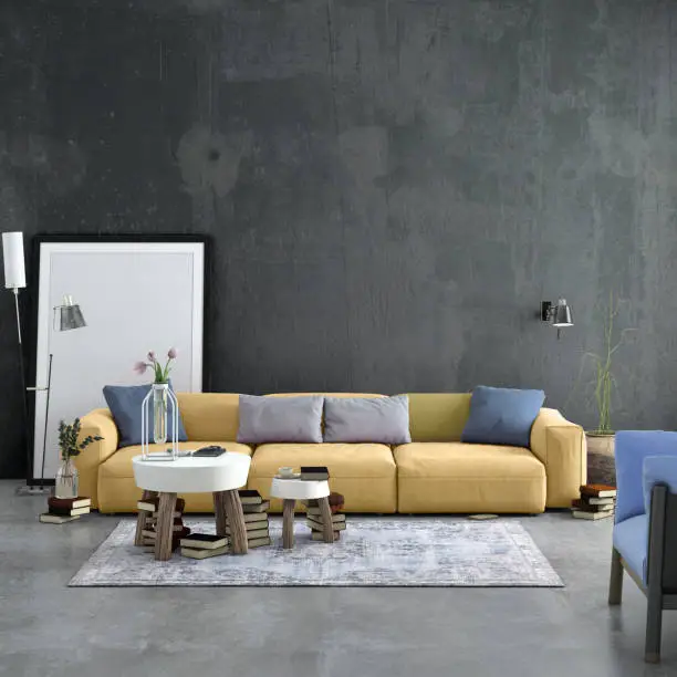 Modern Nordic Scandinavian styled apartment with pastel colored large sofa and picture frame template. Living room scenery with concrete textured wall, concrete floor with carpet, blue armchair, coffee table, electric lamp, plant, books and lots of other details. Copy space mock-up for designers.