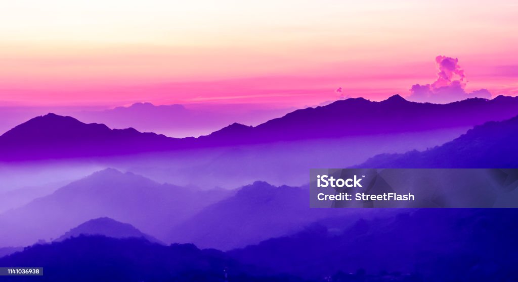 View on purple sunset in the mountains beautiful purple sunset in the mountains Purple Stock Photo