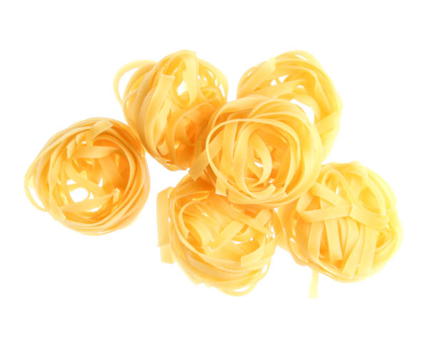 istock Raw dry tagliatelle noodle isolated on white background 1141039505