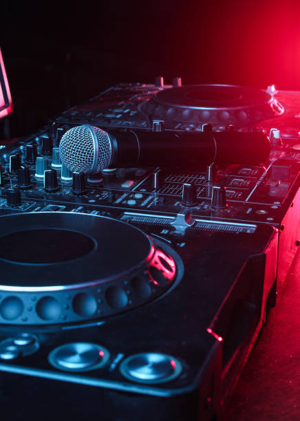 istock Night club, nightlife concept. Disco. Microphone on DJ remote. Neon red blue light 1141040085