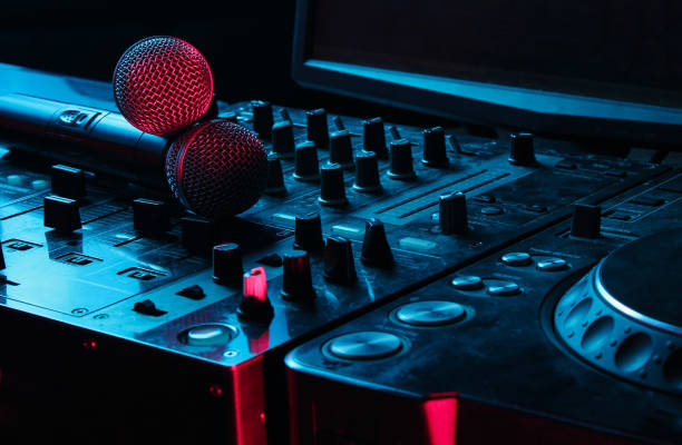 istock Night club, nightlife concept. Disco. Two microphone on DJ remote. Neon red blue light 1141040112
