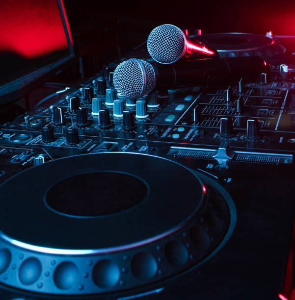 istock Night club, nightlife concept. Disco. Two microphone on DJ remote. Neon red blue light 1141040114