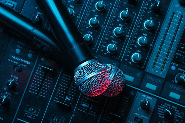 istock Night club, nightlife concept. Disco. Two microphone on DJ remote. Neon red blue light 1141040141