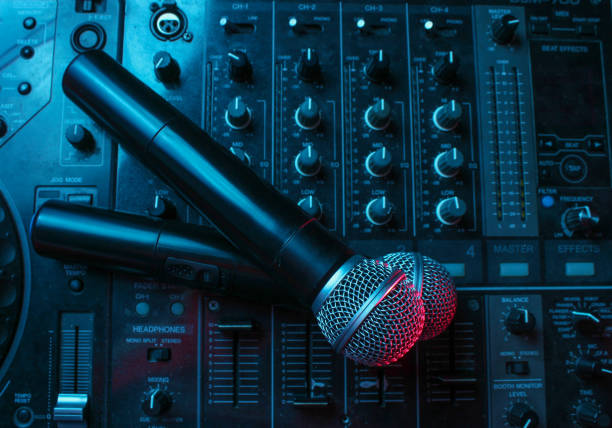 istock Night club, nightlife concept. Disco. Two microphone on DJ remote. Neon red blue light 1141040662