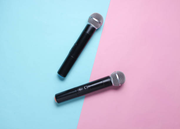 istock Two wireless microphone on blue pink pastel background. Flat lay.  Top view 1141040682