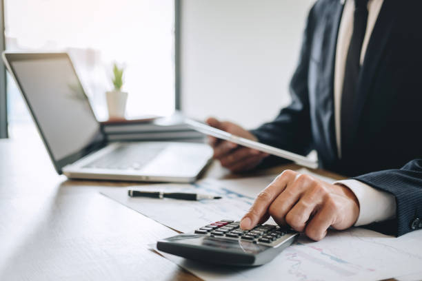 istock Businessman accountant working new project on laptop computer with report document and analyze document graph and diagram, doing finance making notes statistics 1141040857