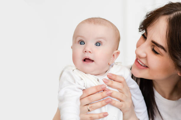 istock Young smiling mother looks at her child. 1141041328