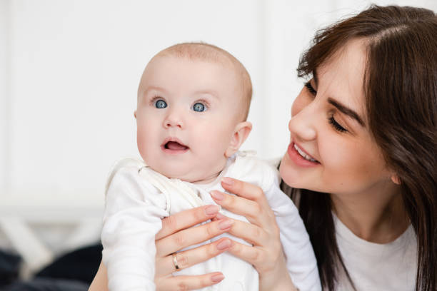 istock Young smiling mother looks at her child. 1141041331