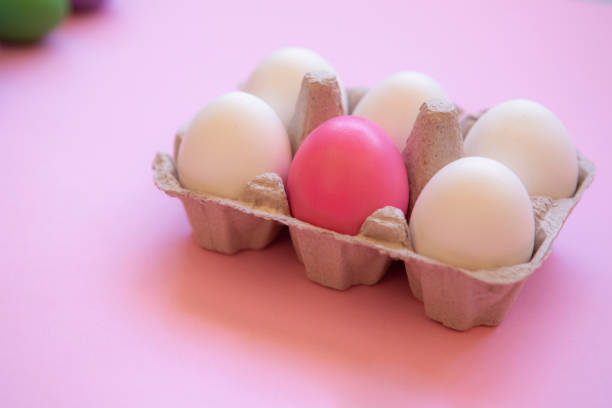 Box of white eggs with hand painted easter egg