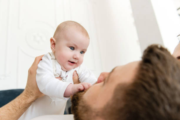 istock Young father hold and look at baby 1141041498