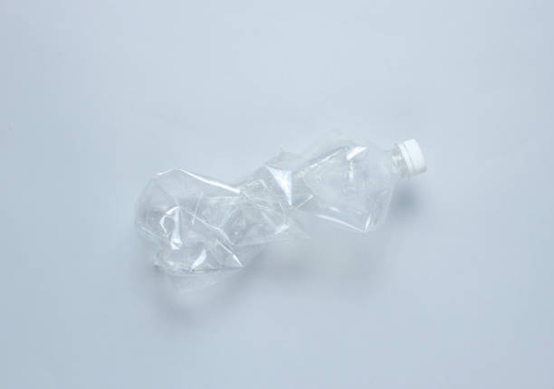istock Minimalistic ecological concept. Crumpled plastic bottle on gray background. Environmental plastic pollution 1141041712
