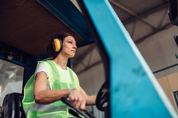 istock Woman forklift operator driving vehicle 1141043704