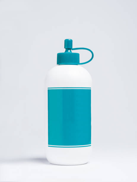 ビニール糊の白と青のプラスチックボトル - glue white education craft ストックフォトと画像