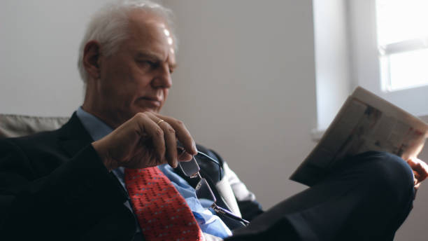 istock Mature businessman with newspaper 1141044710