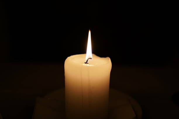 istock Lighted single Candle. Selective focus of candle. Candle fire. Candle on a dark background 1141047727
