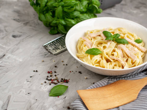 istock Cooked tagliatelle pasta on a plate with Carbonara sauce, bacon 1141049849