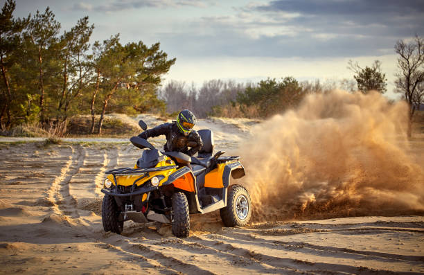 Flying rocks and dust from the wheel of a motocross bike at the start of the race