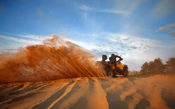 istock Racing in the sand on a four-wheel drive quad. 1141051449