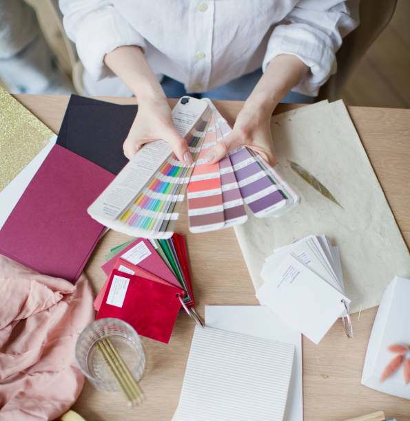 istock Woman at workplace choosing colourful paper charts 1141051468