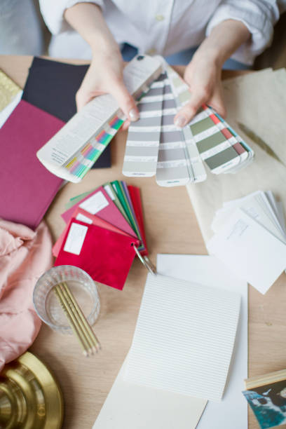 istock Woman at workplace choosing colourful paper charts 1141051477
