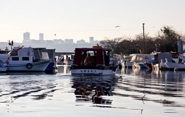 Istanbul, Turkey - February 10, 2019: Fishing boats on kucukcekmece lake. The are lots of people on the boats and near the lake. Lake is 20 kilometers west of the city center on the shores of the Sea of Marmara, having an area of 16 square kilometers.