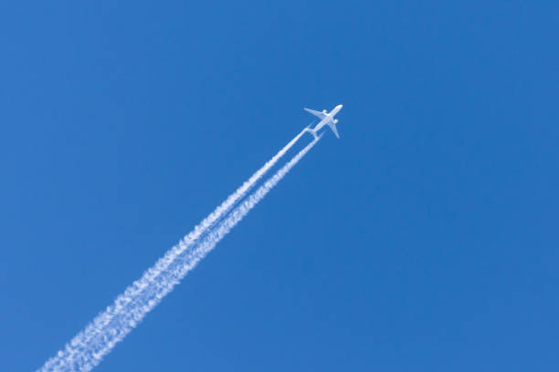 istock Airplanes leaving contrail trace on a clear blue sky. 1141057376