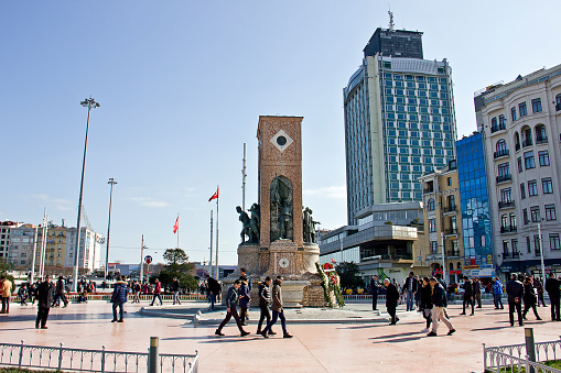 Istanbul, Turkey, February 17, 2019: People walking around Taksim Square in Istanbul. Taksim is the region preferred by tourists at the same time. Thera are istiklal Avenue down the square that known in English as Independence Avenue, the most famous shopping street in the country sees as many as three million pedestrians on a busy weekend day.