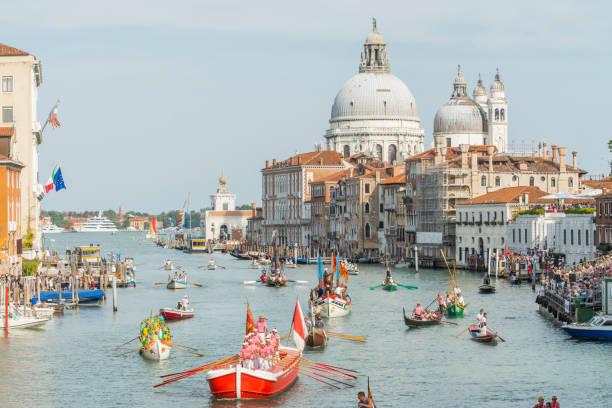 Historical Regatta ('Regata Storica') at Venice, Italy. Every first Sunday of September takes place the Historical Regatta ('Regata Storica'), a competition between Venetian boats and gondolas. This famous and important event is watched by thousands of people from the banks or from floating stands. Gondoliers in typical 16th century costumes sail the Grand Canal from Piazza San Marco to Rialto Bridge. gondola traditional boat stock pictures, royalty-free photos & images