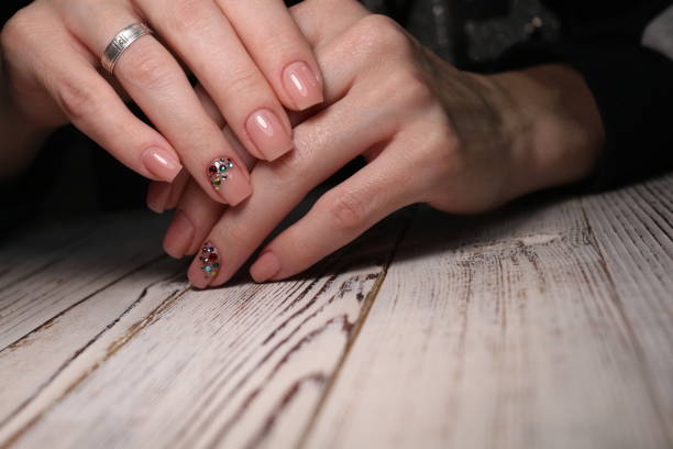 istock Partial view of manicurist gently holding hand 1141060354