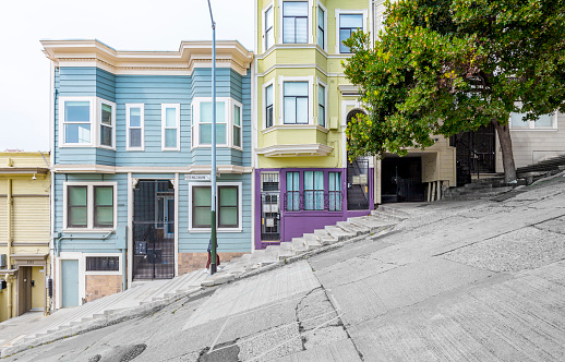 Classic urban scene of historic colorful buildings along one of San Francisco's steepest streets near Telegraph Hill residential area district on a beautiful sunny day in summer, SF, California, USA