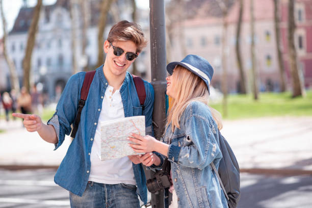 istock Happy young couple in town with a map 1141063200