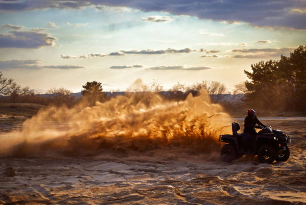 istock Racing in the sand on a four-wheel drive quad. 1141064073