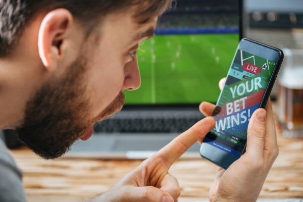istock Man celebrating victory after making bets at bookmaker website 1141067145