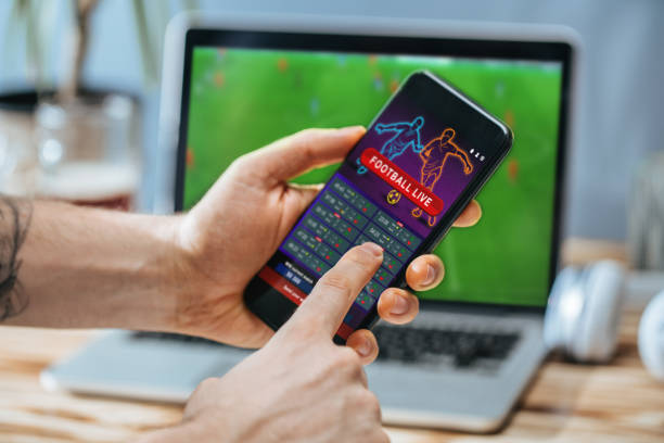 istock Man celebrating victory after making bets at bookmaker website 1141067177