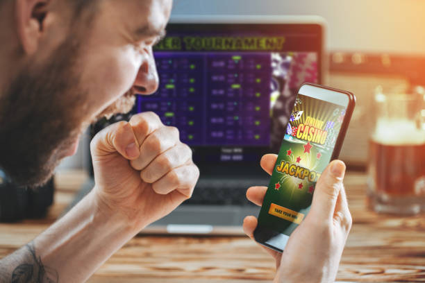 istock Man celebrating victory after making bets at bookmaker website 1141067217