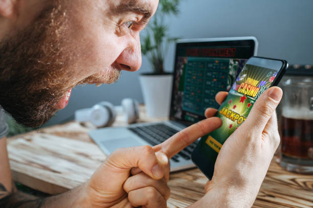 istock Man celebrating victory after making bets at bookmaker website 1141067227