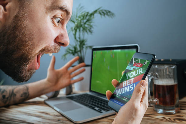 istock Man celebrating victory after making bets at bookmaker website 1141067748