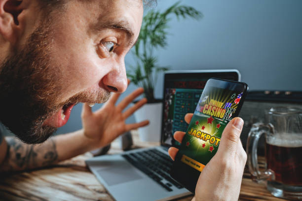 istock Man celebrating victory after making bets at bookmaker website 1141068269